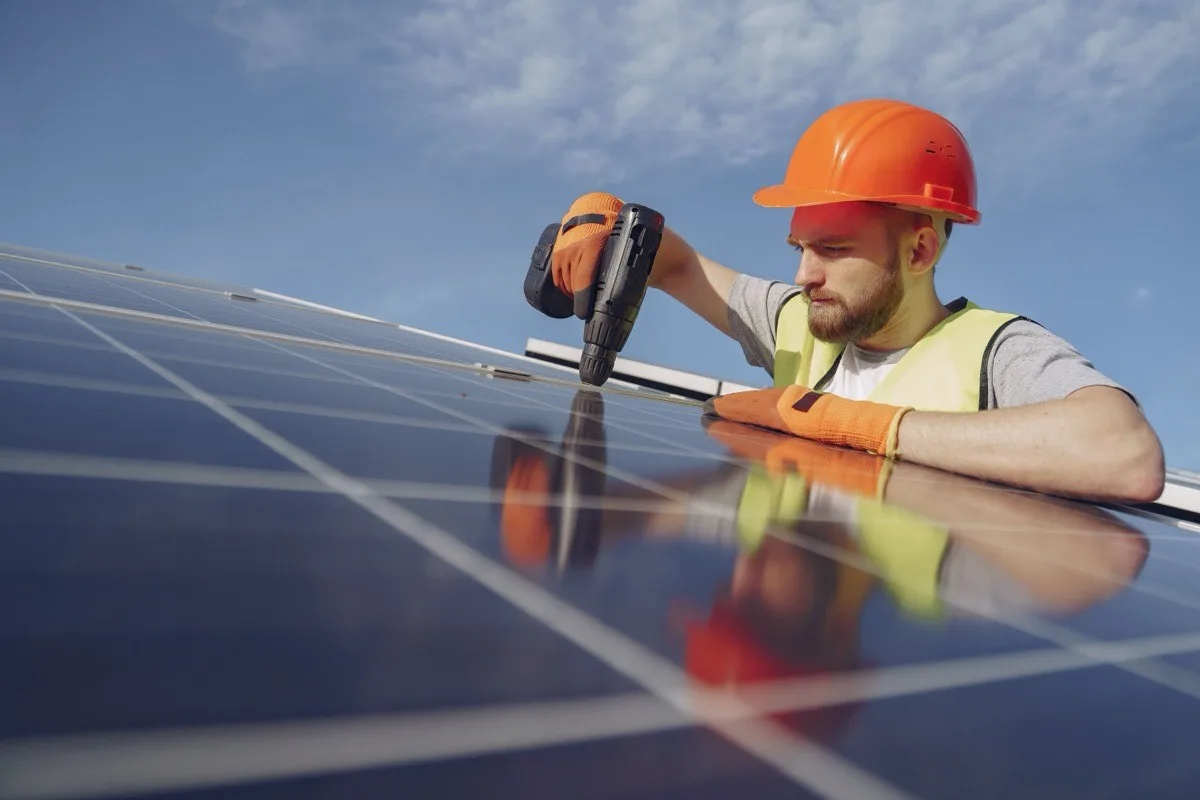 Accredited engineer carefully fitting a commercial solar panel